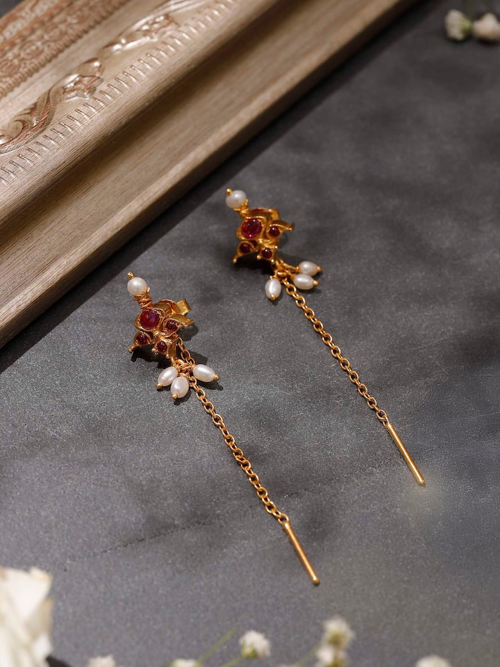 Styled detail view of Guttapusalu Silver Drop Earrings worn on the ear, shown in another styled shot