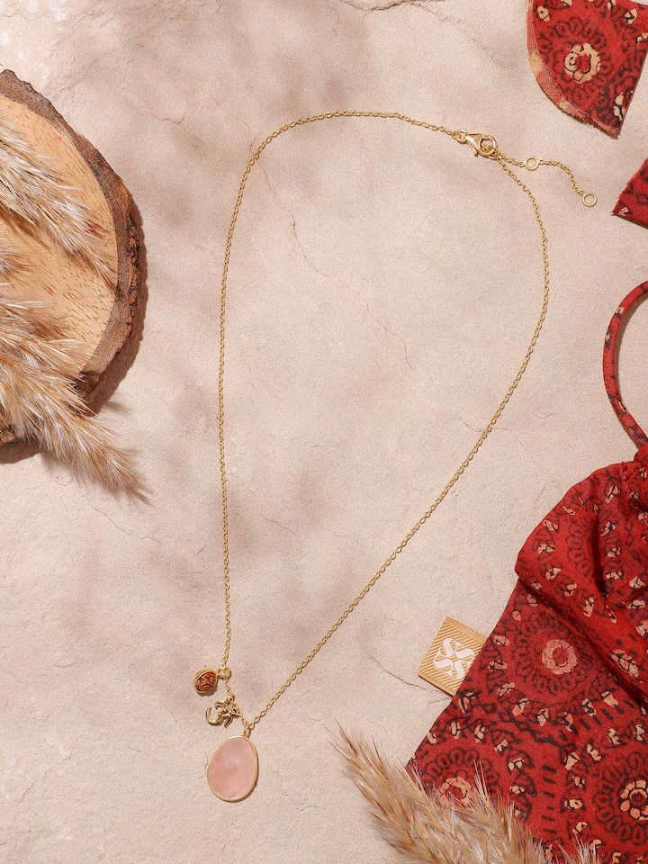 Close-up of Rudraksha, Om Charm & Rose Quartz Necklace showcasing the detailed charm and natural texture of Rudraksha