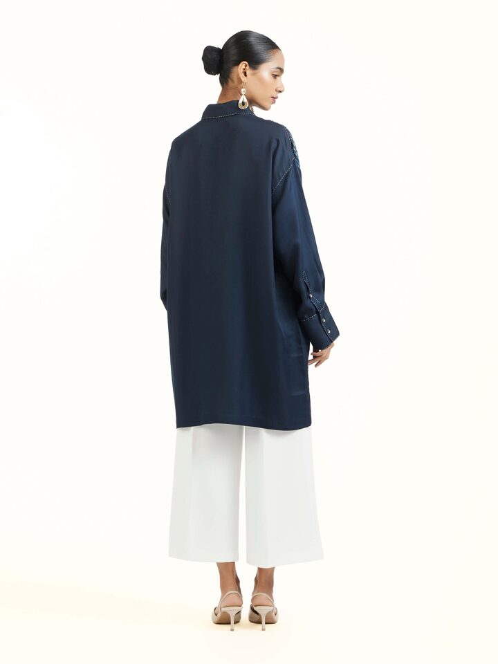 Back view of blue shibori long shirt showing full length design
