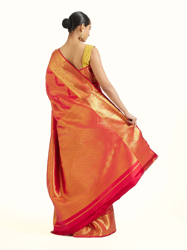 Back view of red silk Kancheepuram saree displaying ornate pallu design