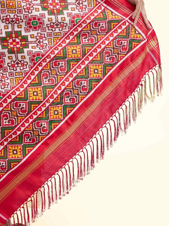 Detail view of pink ikat Patan Patola handwoven dupatta showing silk texture