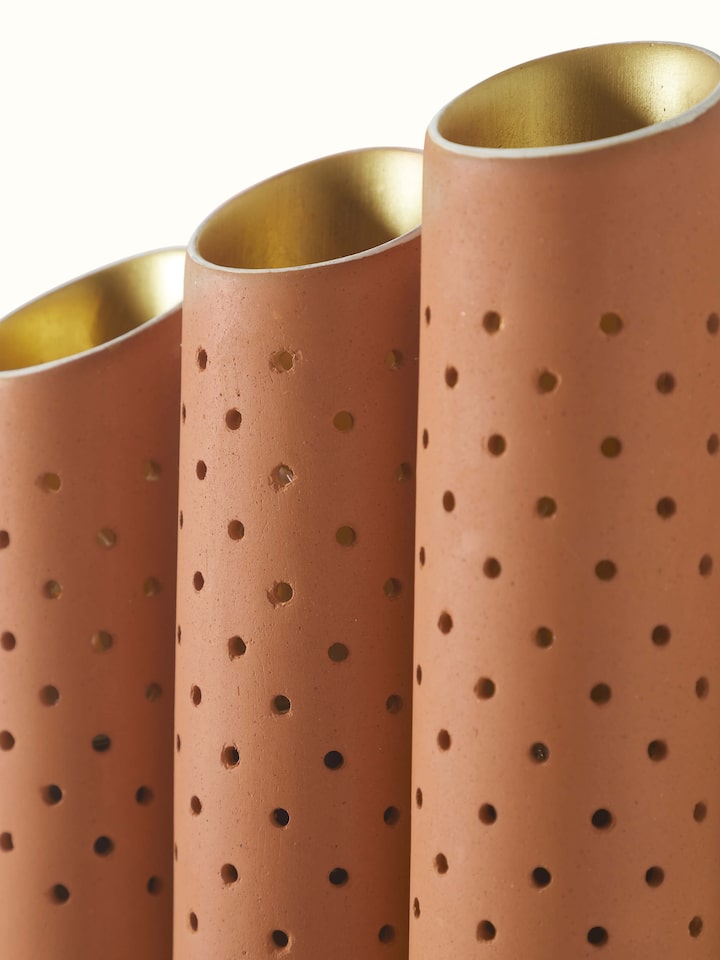 Detailed view of natural terracotta wall light, showcasing the intricate patterns and texture.
