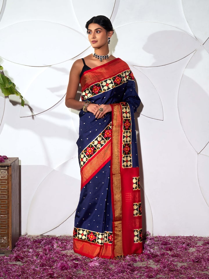 Side view of blue silk Pochampally double ikat saree highlighting fluid drape