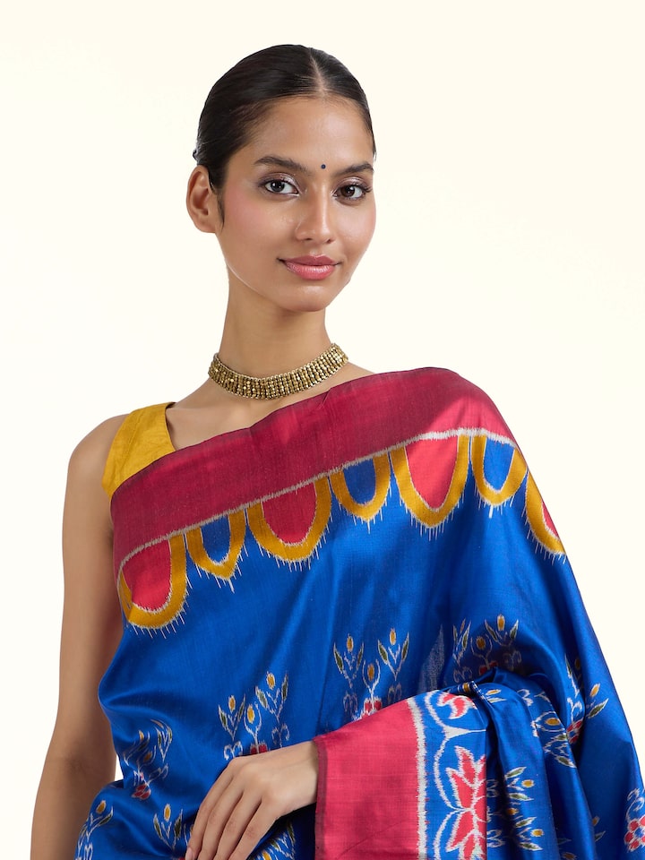 Angled view of blue mulberry silk bandha Odisha ikat saree emphasizing bandha weave