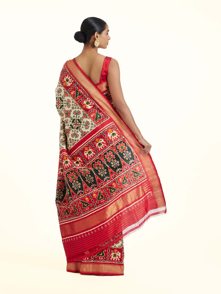 back view of cream pochampally double ikat silk saree