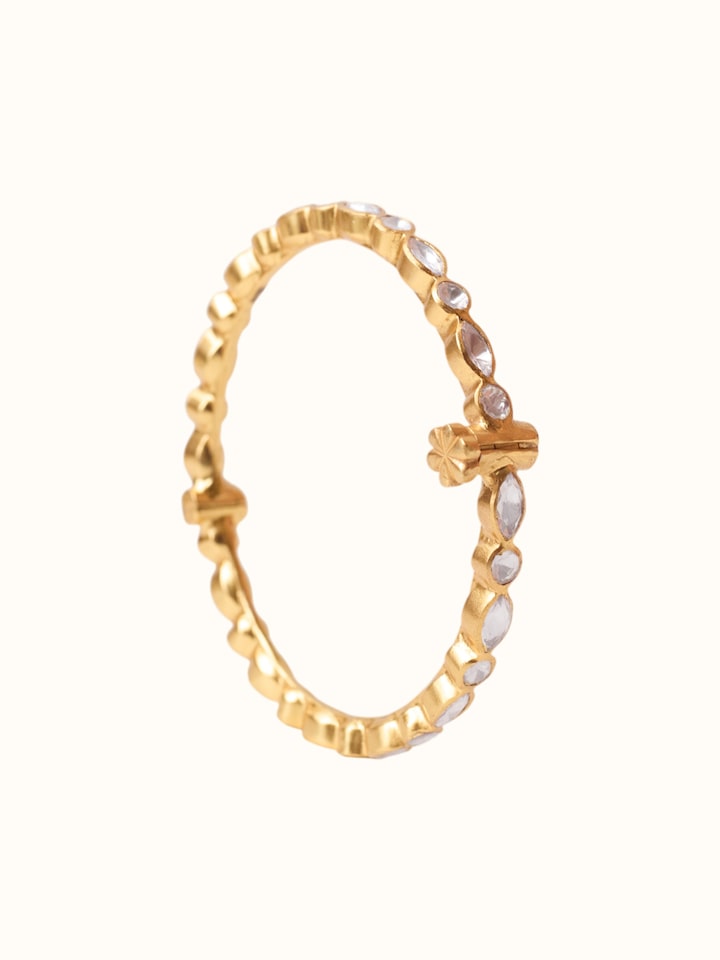 angled view of silver smithing gold plated bangle