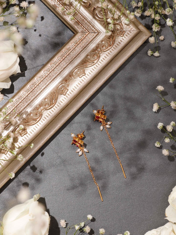 Styled detail view of Guttapusalu Silver Drop Earrings worn on the ear, shown in an alternate styled shot