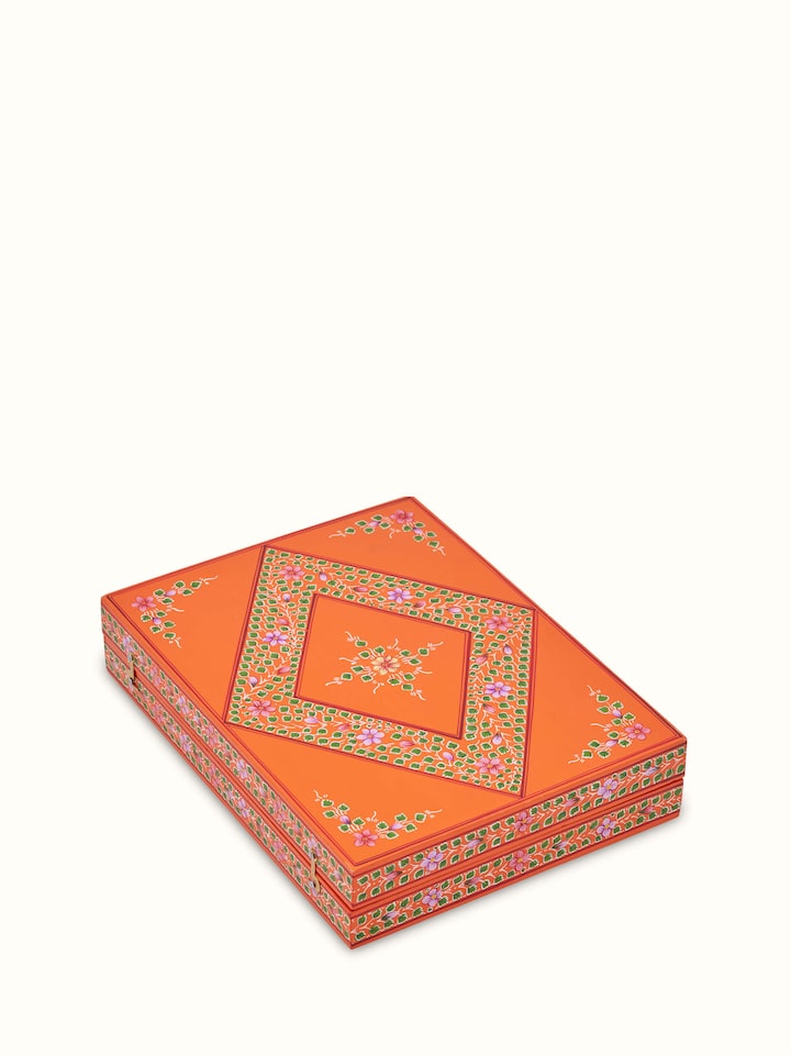 Close-up view of Ganjifa cedar wood backgammon in orange showcasing the detailed artwork and smooth cedar finish