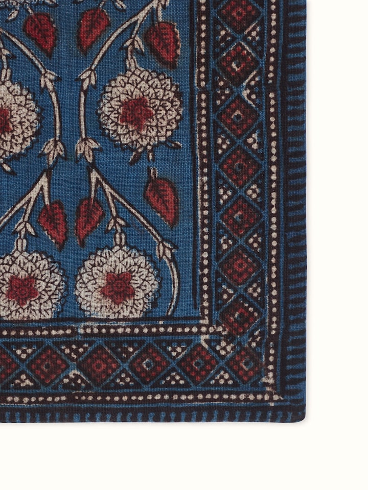Detail view of indigo cotton Dabu hand block printed table runner highlighting the repeat pattern and border