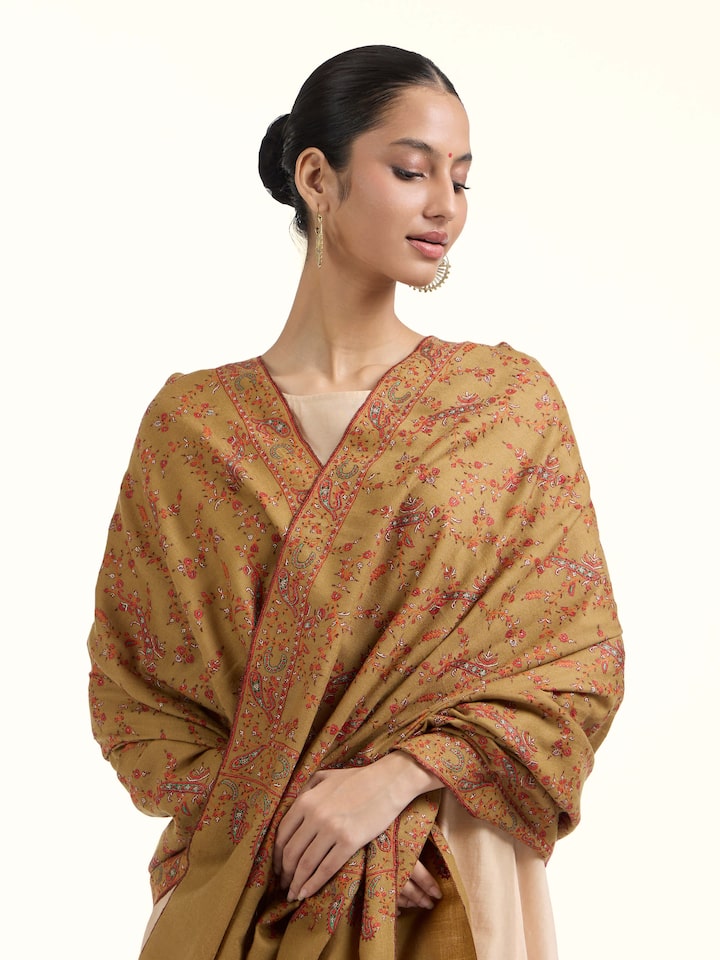 Angled view of green jalidar sozni embroidered shawl highlighting jalidar pattern