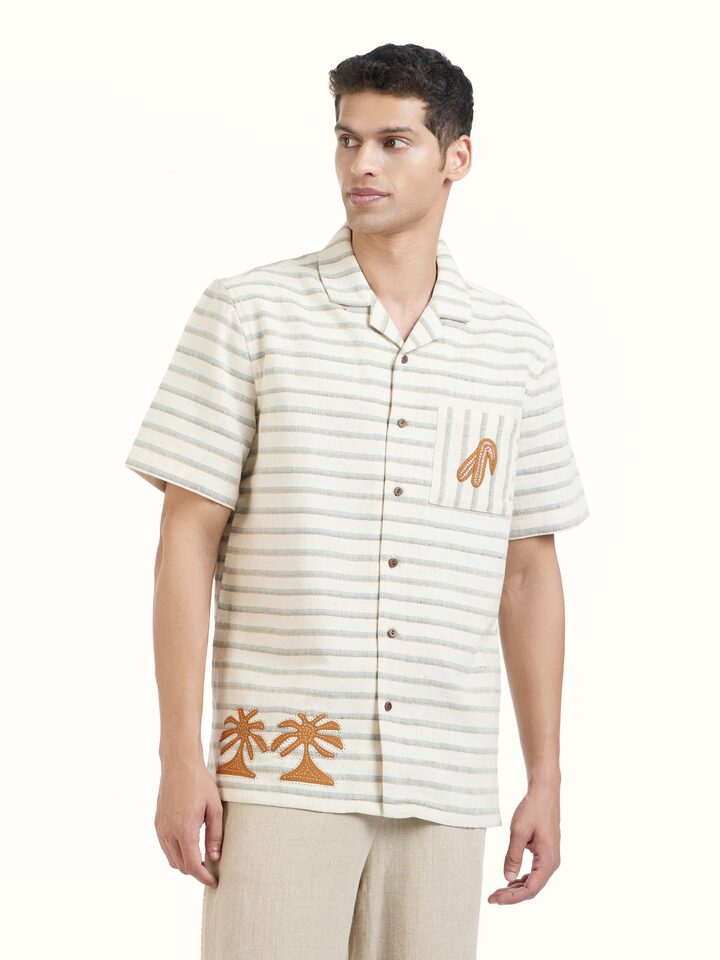 Angled view of Ivory Kutchi Embroidered Shirt revealing the depth of its color and intricate pattern