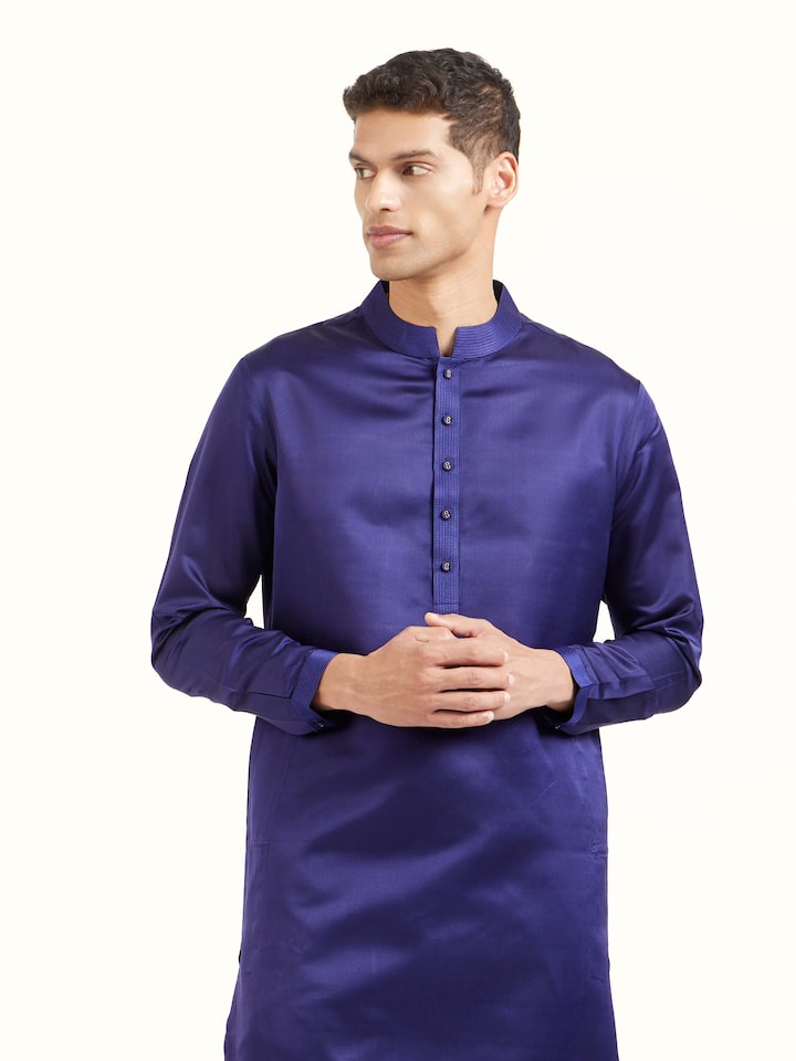 Angled view of navy blue katan silk Banarasi midi kurta pant set highlighting zari work
