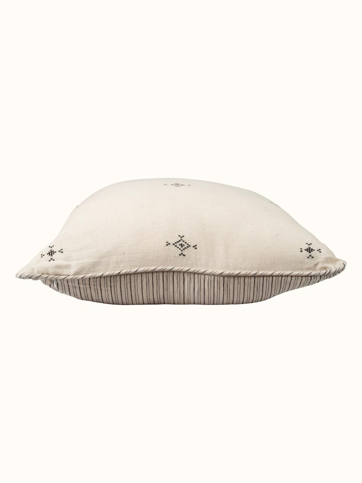 Folk geo hand embroidered bootis cushion cover, angled view highlighting pattern