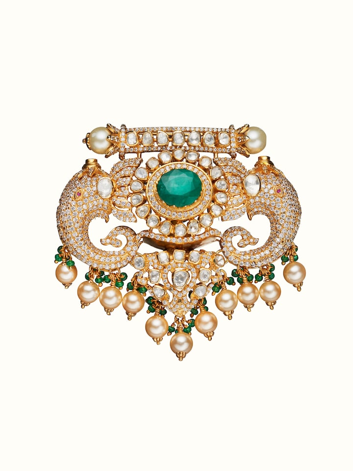front view of silver smithing yellow gold brooch pin with intricate design