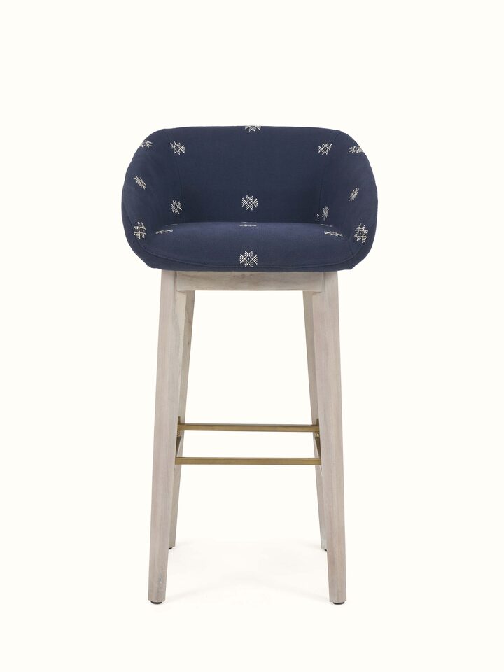 Featuring an upholstered design with acacia wood, ideal for bar settings.