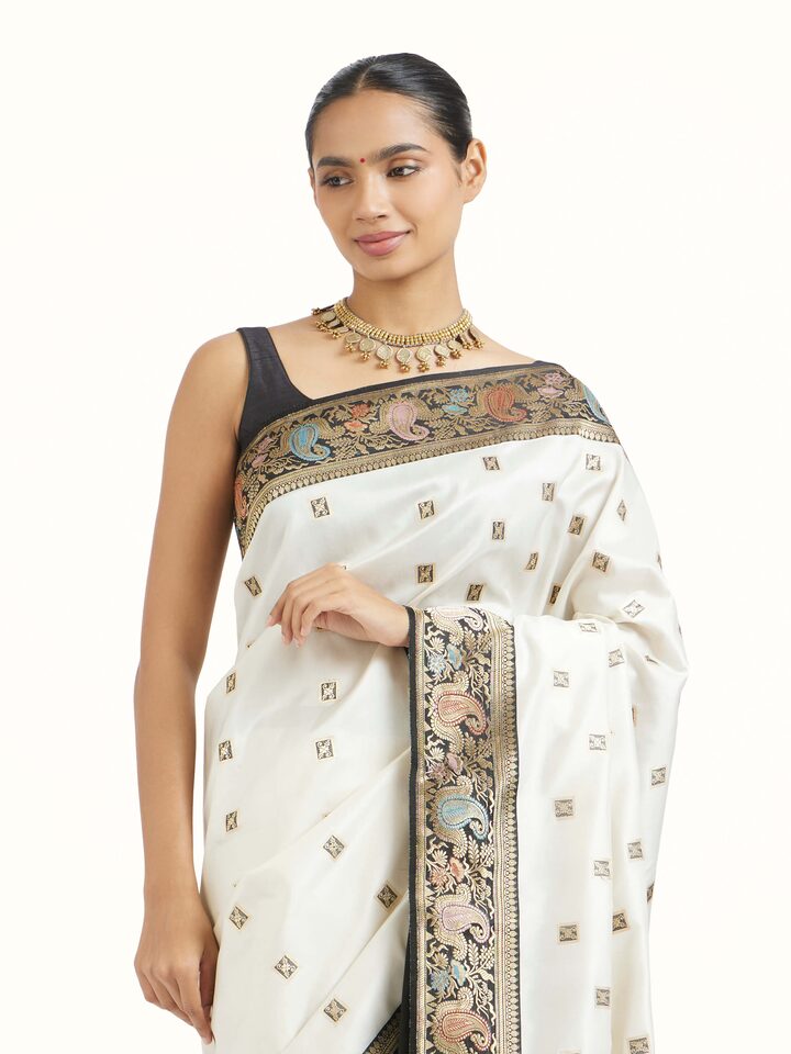 Angled view of Off-white Banarasi Kadhwa Silk Saree revealing the depth of its color and intricate pattern