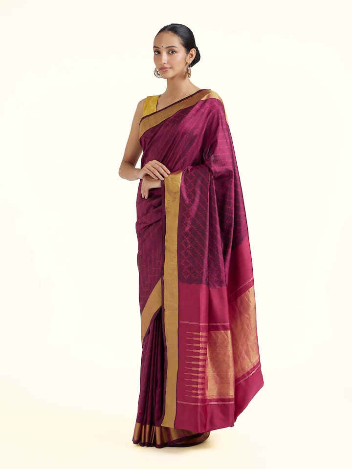 Side view of purple mulberry silk ikat saree with graceful drape and patterned border
