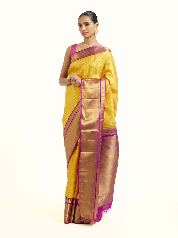Side view of yellow silk Kancheepuram saree showcasing contrast border