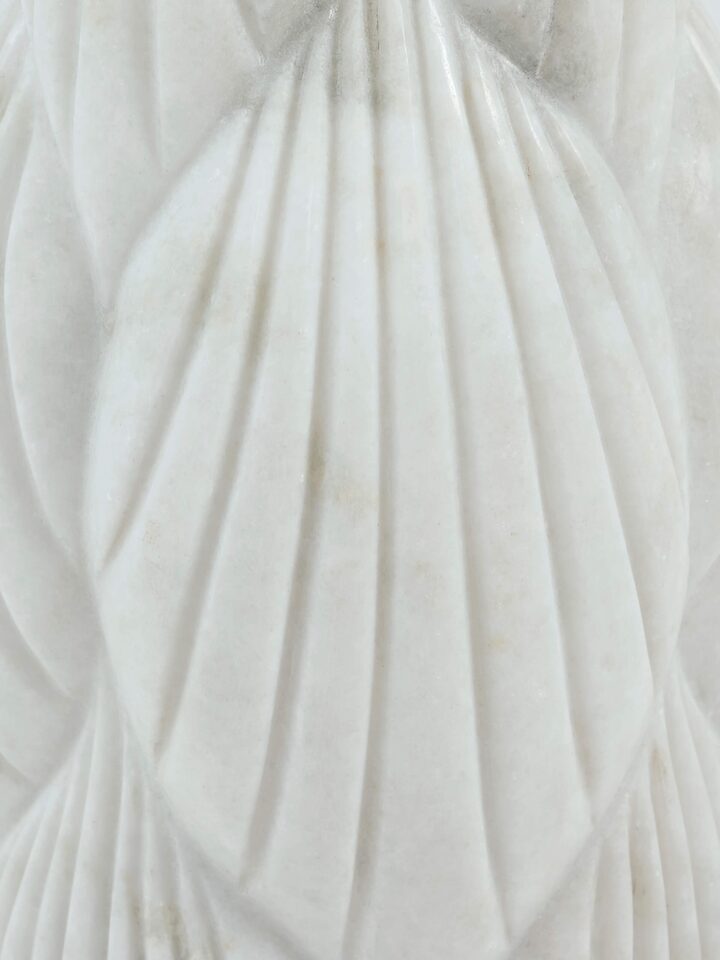 Detail view of marble floor vase carving patterns