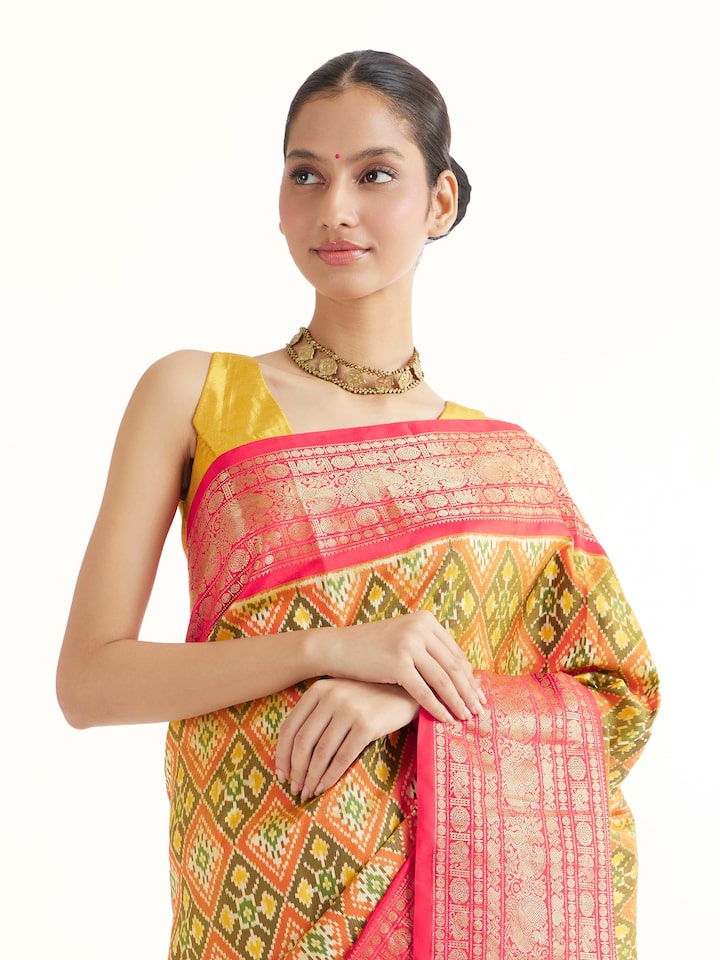Angled view of green silk ikat saree highlighting ikat craftsmanship