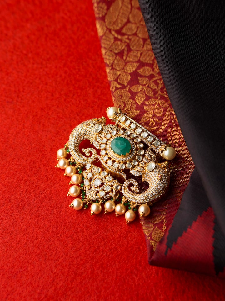 detail view of silver smithing yellow gold brooch pin pattern