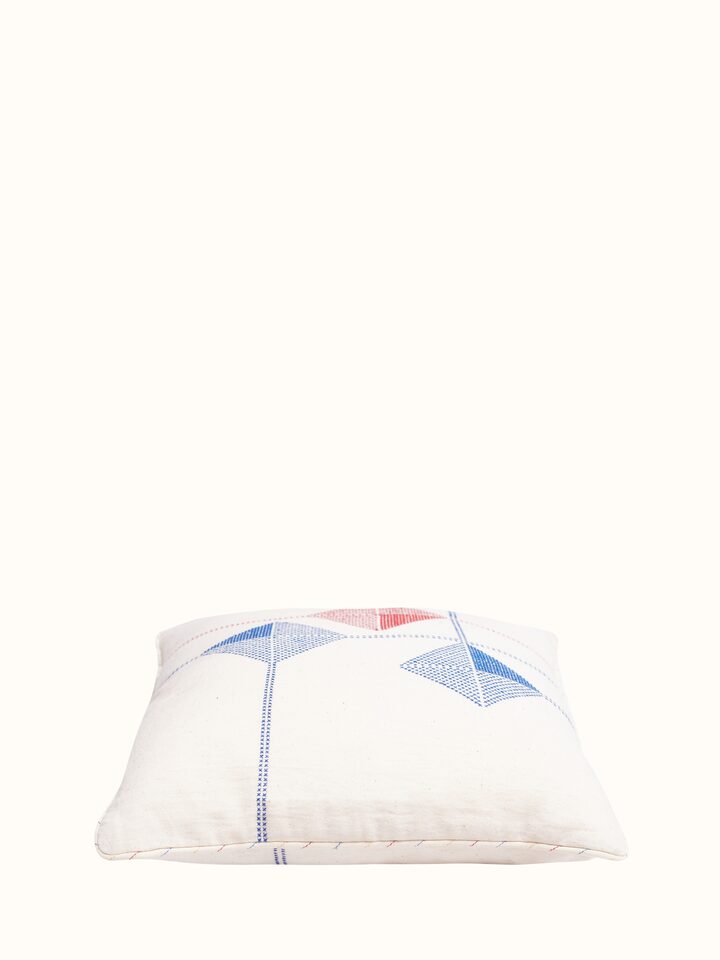 Angled view of Uttarayan Kutch Jat embroidered cotton cushion cover