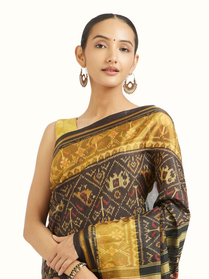 Angled view of Rajkot Patola Ikat Saree revealing the depth of its color and intricate pattern