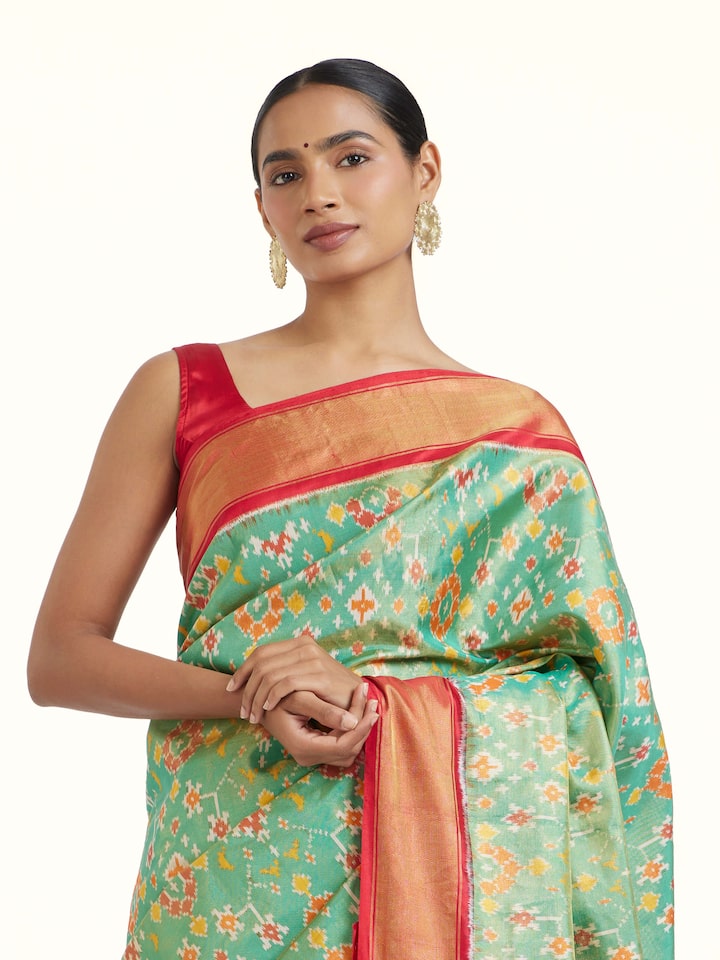 Angled view of Brown Pochampally Ikat Silk Saree revealing the depth of its color and intricate pattern