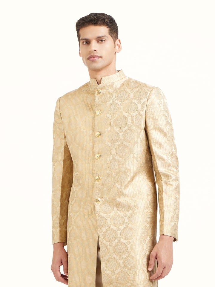 Angled view of beige silk traditional butidar Banarasi handloom brocade men’s sherwani highlighting brocade work