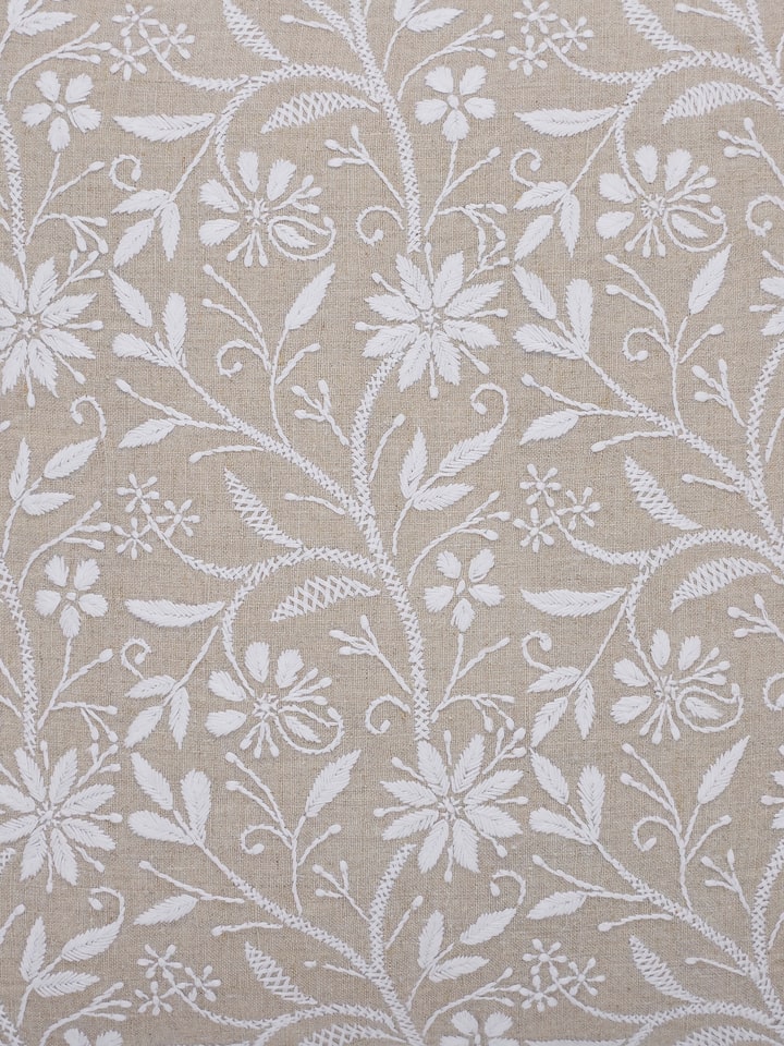 Detail view of Rann Beige Allover Linen Chikankari Hand Embroidered Cushion Cover highlighting the fabric texture and embroidery detail