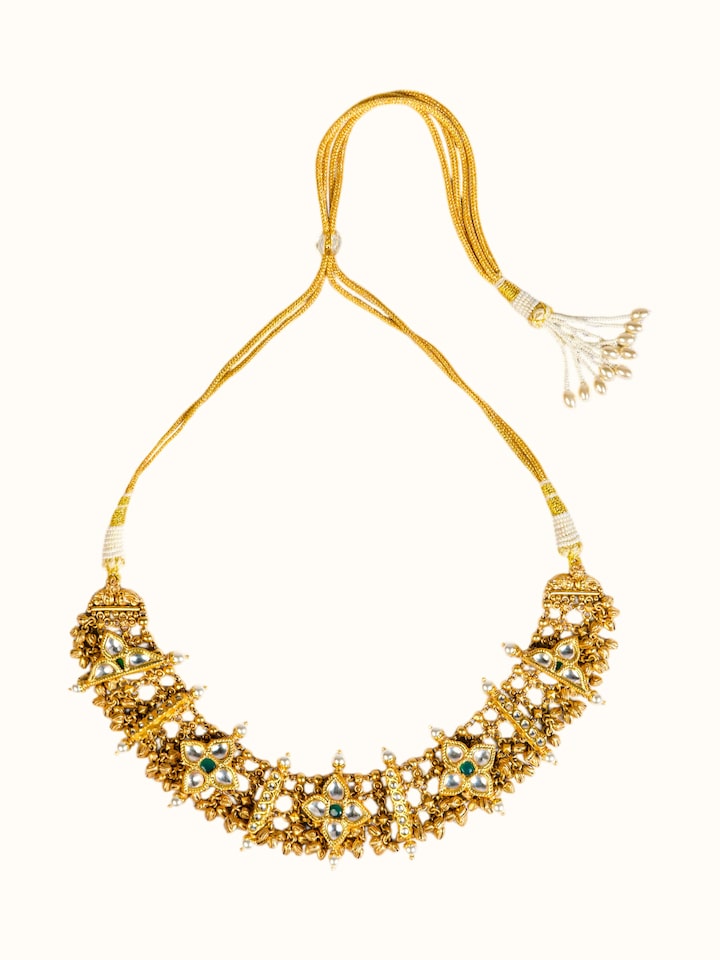 front view of silver smithing gold plated kundan necklace with traditional stone setting