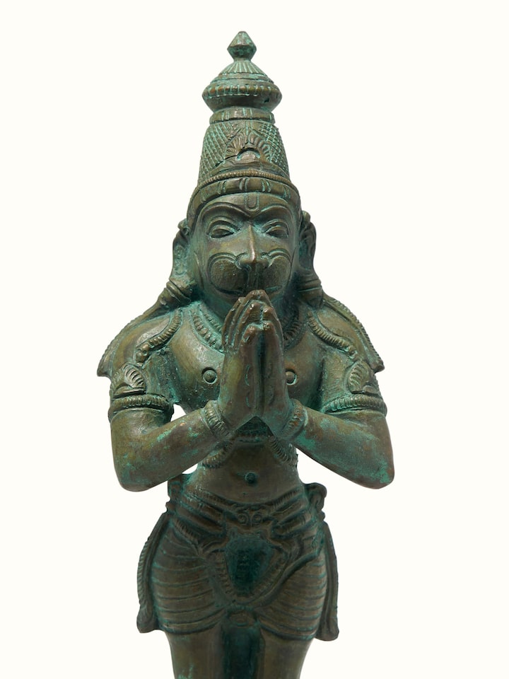 Close-up detail of bronze Hanuman casting idol showing metalwork