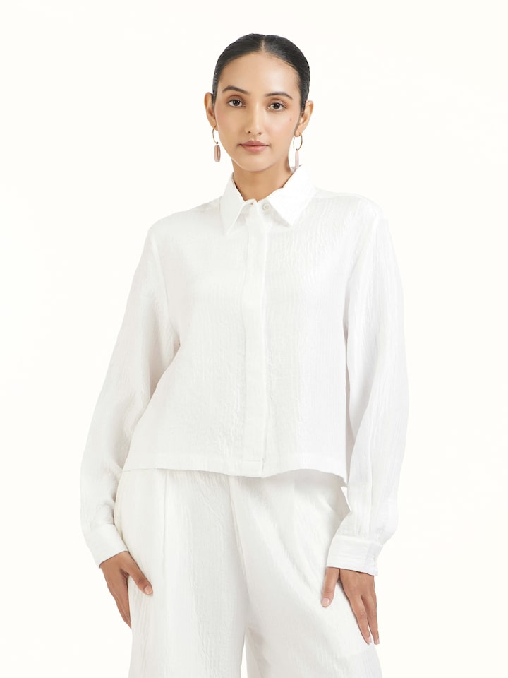 Angled view of ivory quilted silk shirt highlighting quilted detailing