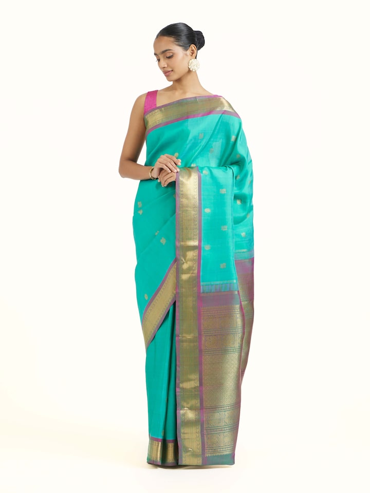 Side view of blue silk Kancheepuram saree showcasing flowing drape