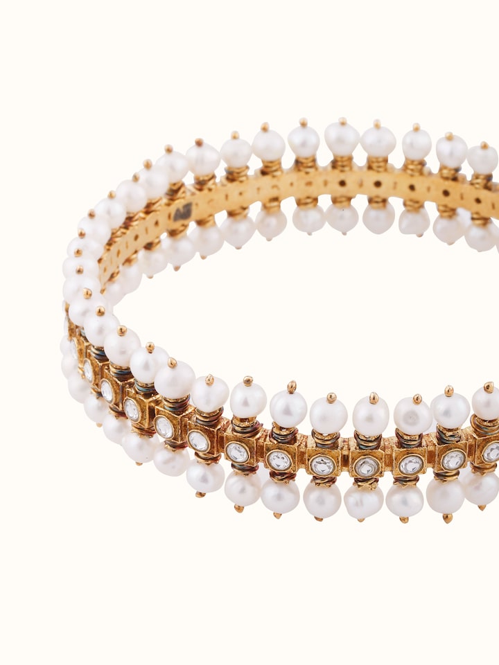 Overhead view highlighting the bangle’s circular structure and ornamental design.