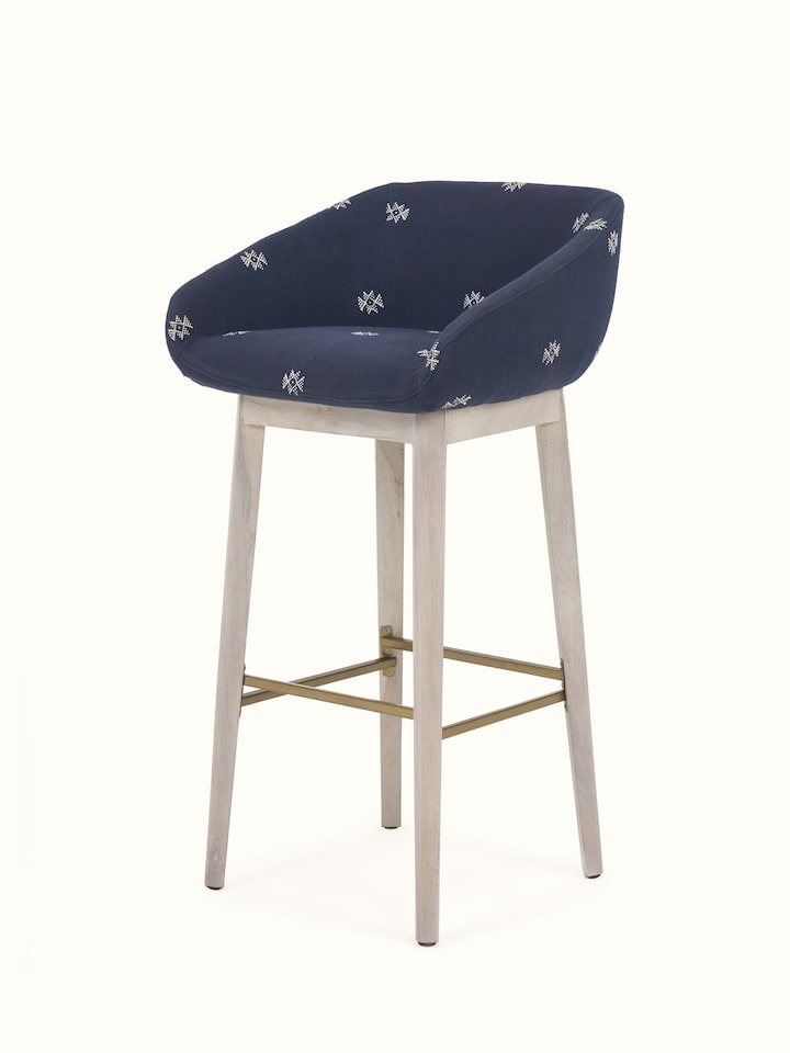 Angled view highlighting the upholstered acacia wood bar chair.