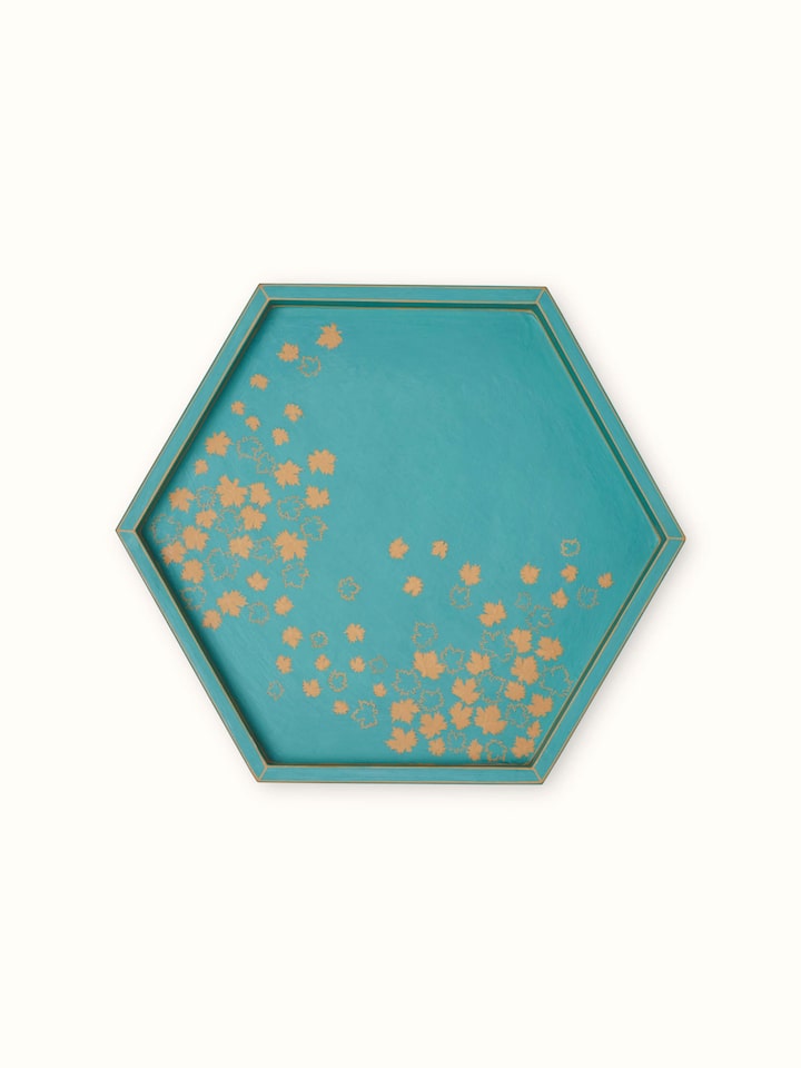 Close-up of papier-mâché decorative tray, focusing on the intricate details and vibrant colors.