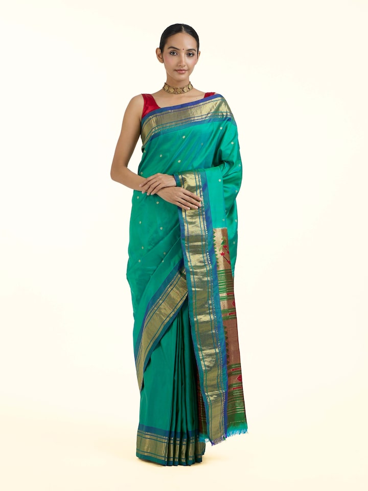 Front view of green silk Paithani saree showcasing rich colour and traditional motifs