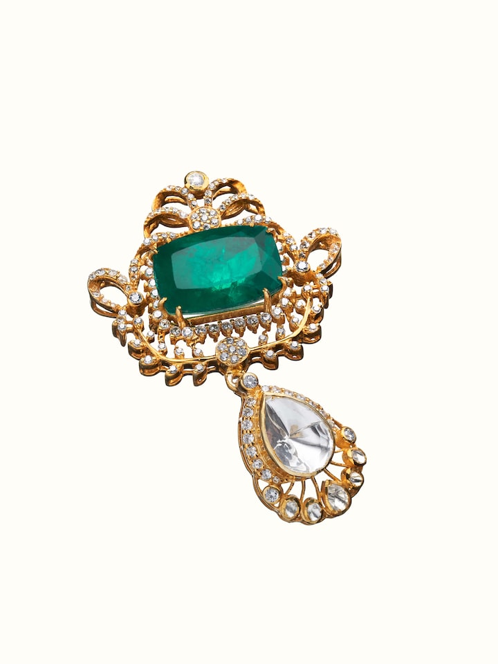angled view of silver smithing yellow gold brooch pin