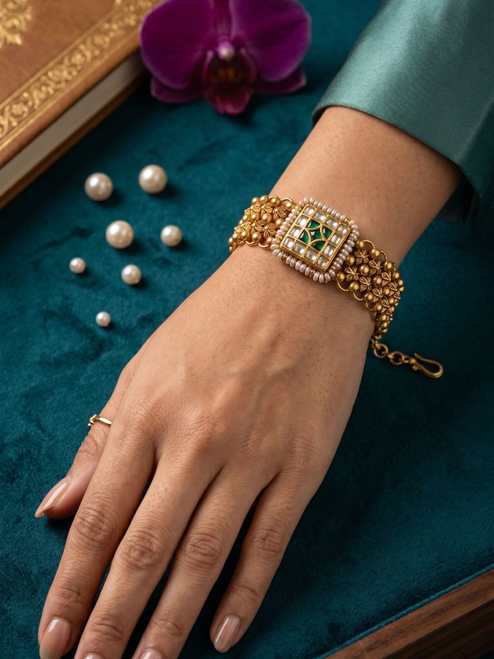 Styled view of Silver Smithing Gold Plated Thappa Motif Wristwear worn on the wrist, showing how it looks styled