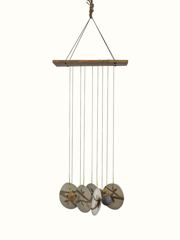Front view of Tranquil Ceramicware Clay Wind Chime showcasing its soothing design and intricate ceramic work