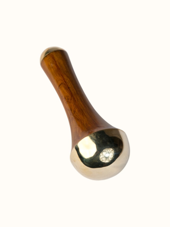 Side-angle view of the Kansa Wand Ayurvedic Facial and Body Massage Tool