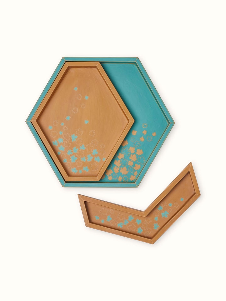 Angled view of papier-mâché decorative tray, showing its decorative elements and colorful design.