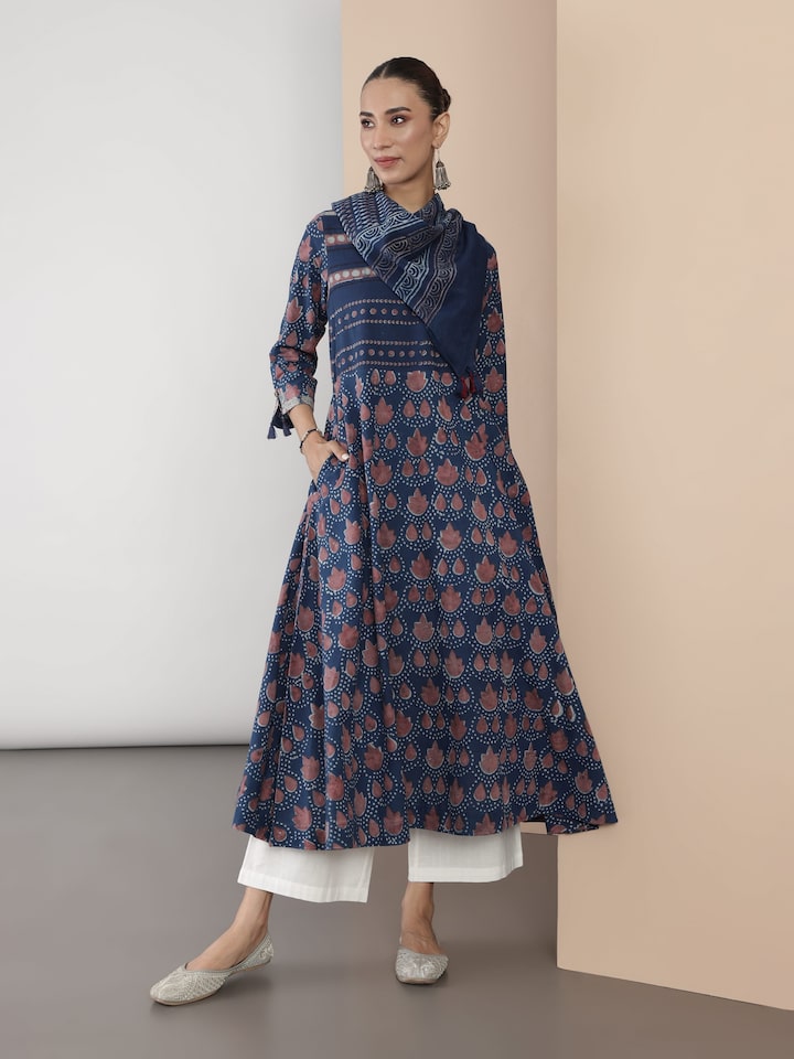 Angled view of blue cotton Dabu block print A-line kurta showing print details and fabric fall.