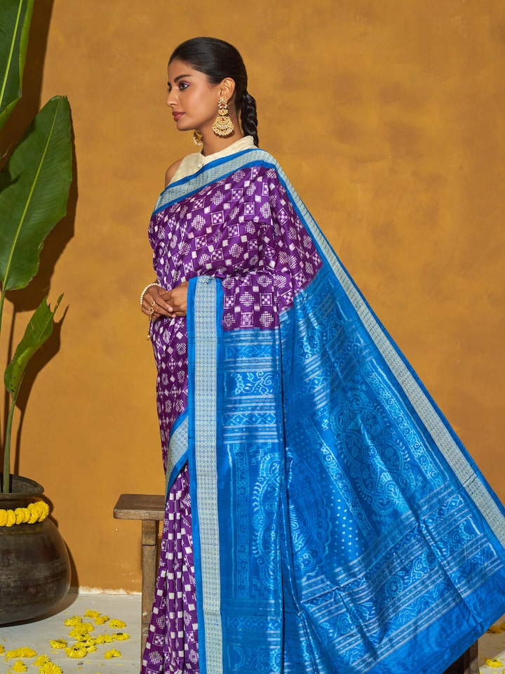 Angled view of turquoise mulberry silk bandha Odisha ikat saree showcasing traditional patterns