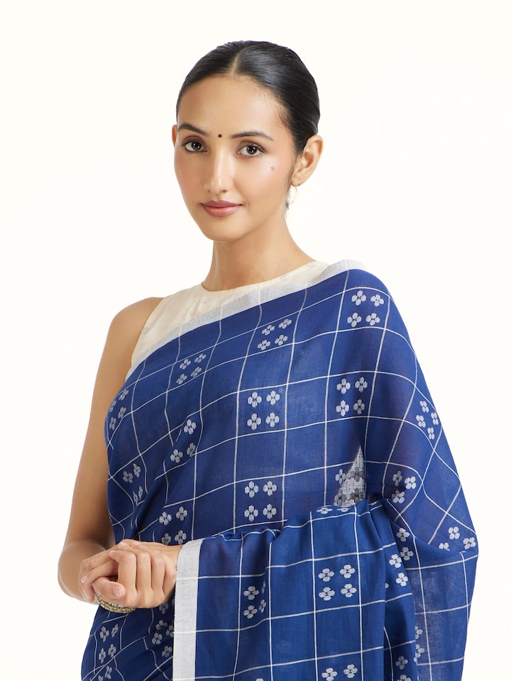Angled view of Blue Muslin Jamdani Saree revealing the depth of its color and intricate pattern