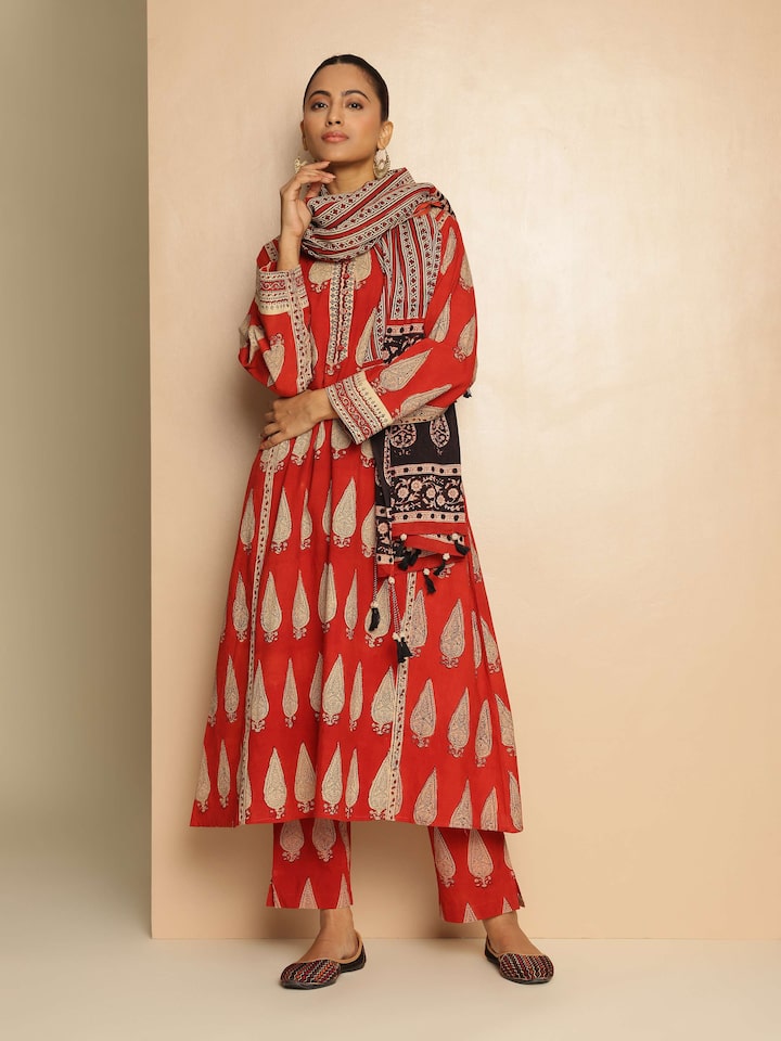 Lifestyle view of red Bagru block printed cotton pant styled casually