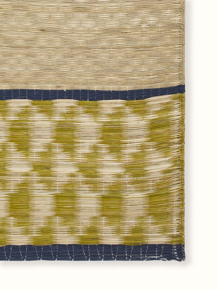 Close-up of geometric weave pattern on Madurkathi green table mat