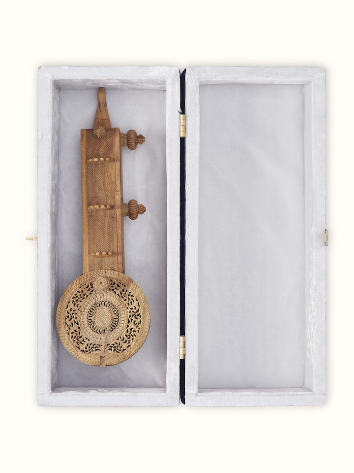 Detailed view of carved sandalwood Vandana Veena sculpture showcasing fine carving work