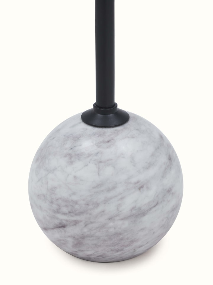 Close-up view of carved marble & metal end & side table highlighting intricate metalwork details